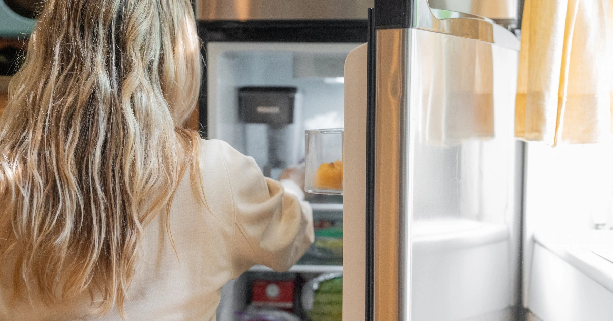 A simple white kitchen refrigerator that may need servicing, helping homeowners estimate their upcoming refrigerator repair cost.